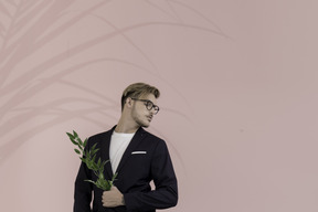 Portrait of a young man holding a laurel branch