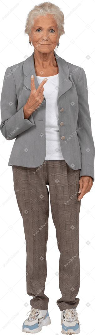 Front view of an old lady in suit showin v sign