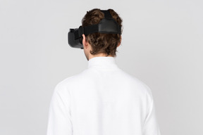 Back view of man in virtual reality headset