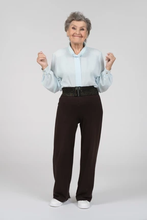 Front view of an old woman smiling with thumbs up