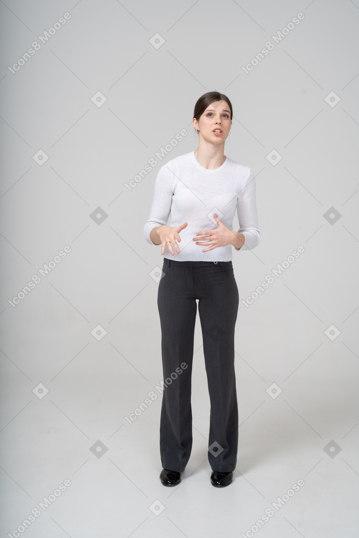 Front view of a young woman in suit gesturing
