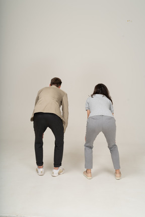 Back view of young man and woman leaning on knees