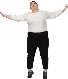 Front view of a plus size woman in casual clothes looking up