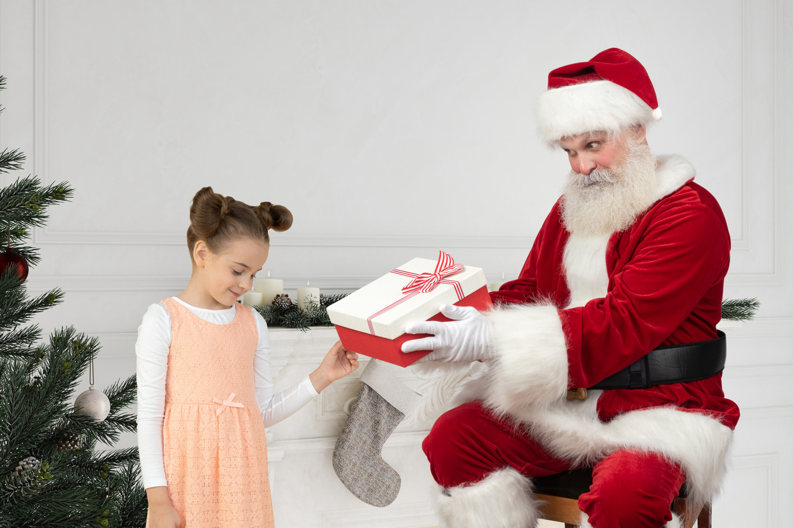 Santa claus gives gift to little girl