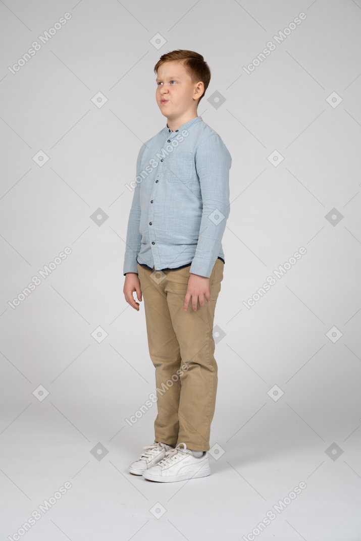 Boy standing still and making faces