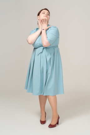 Вид спереди женщины в синем платье позирует