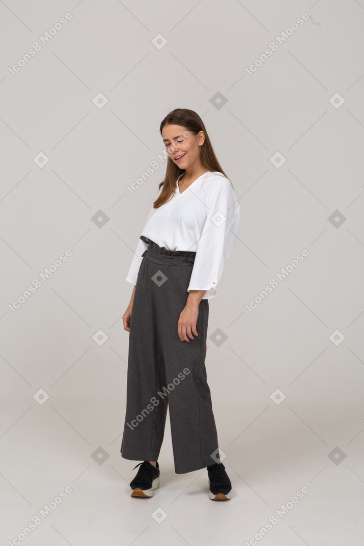 Front view of a winking young lady in office clothing
