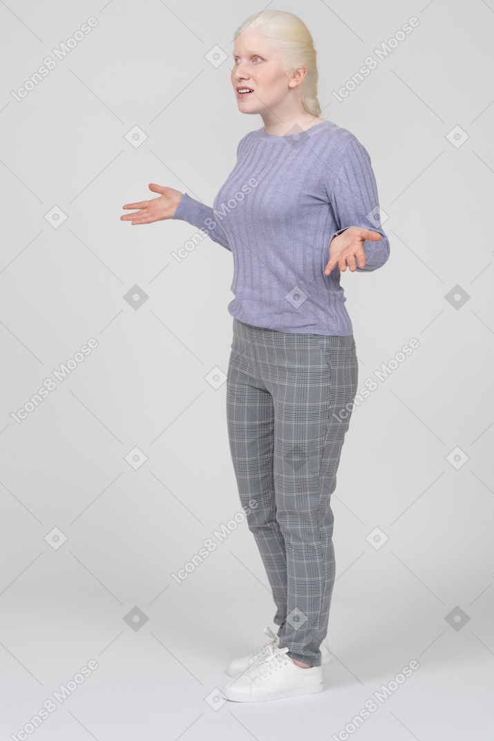 Young woman spreading arms and talking