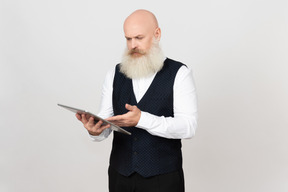 Aged man centred on using ipad