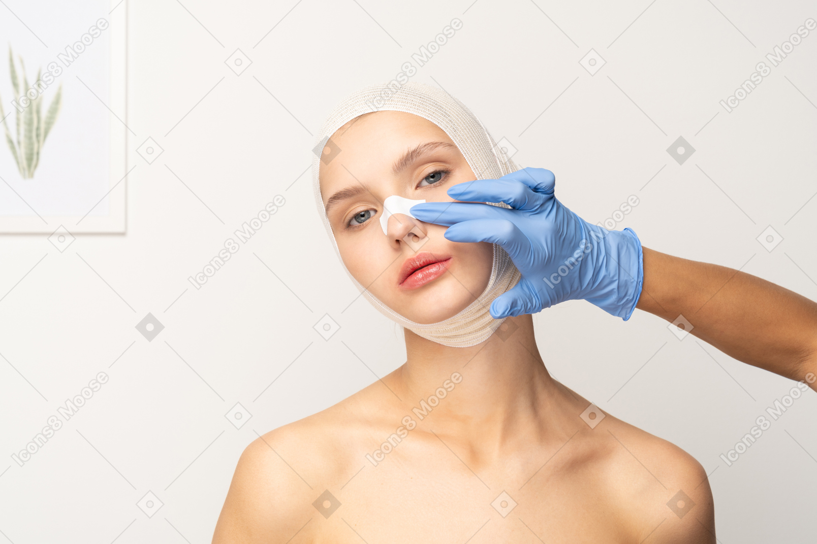 Female patient with hand putting a band aid on her nose
