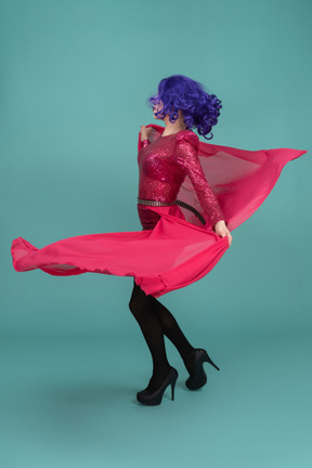 Drag queen spinning around in pink flowing skirt