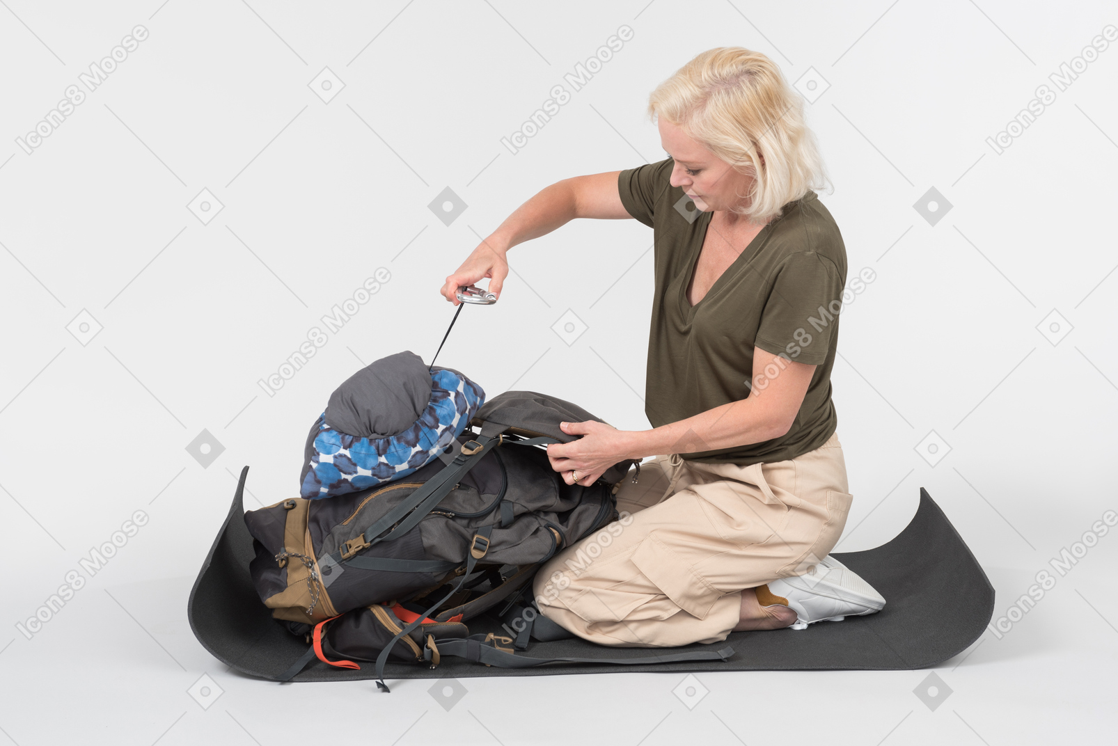 Mature female tourist organising tourist backpack