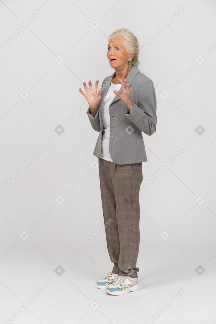 Scared old lady in suit standing in profile