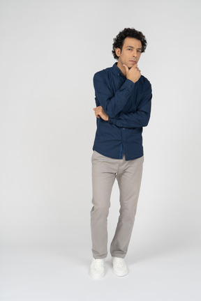 Front view of a man in casual clothes thinking