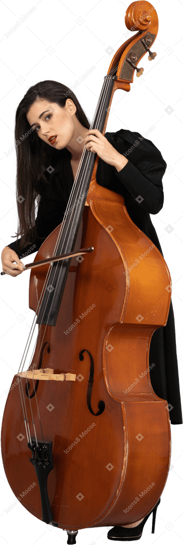 弓でコントラバスを演奏する黒いドレスを着た若い女性の4分の3のビュー