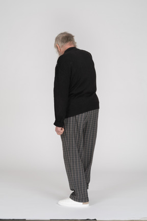 Rear view of old man bending head down