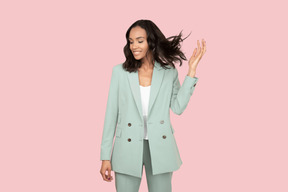 A woman in a light green blazer and pants