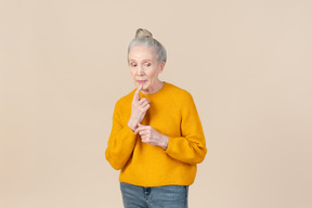 Elegant older woman in a mustard sweater