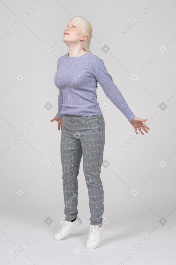 Young woman in casual clothes jumping up