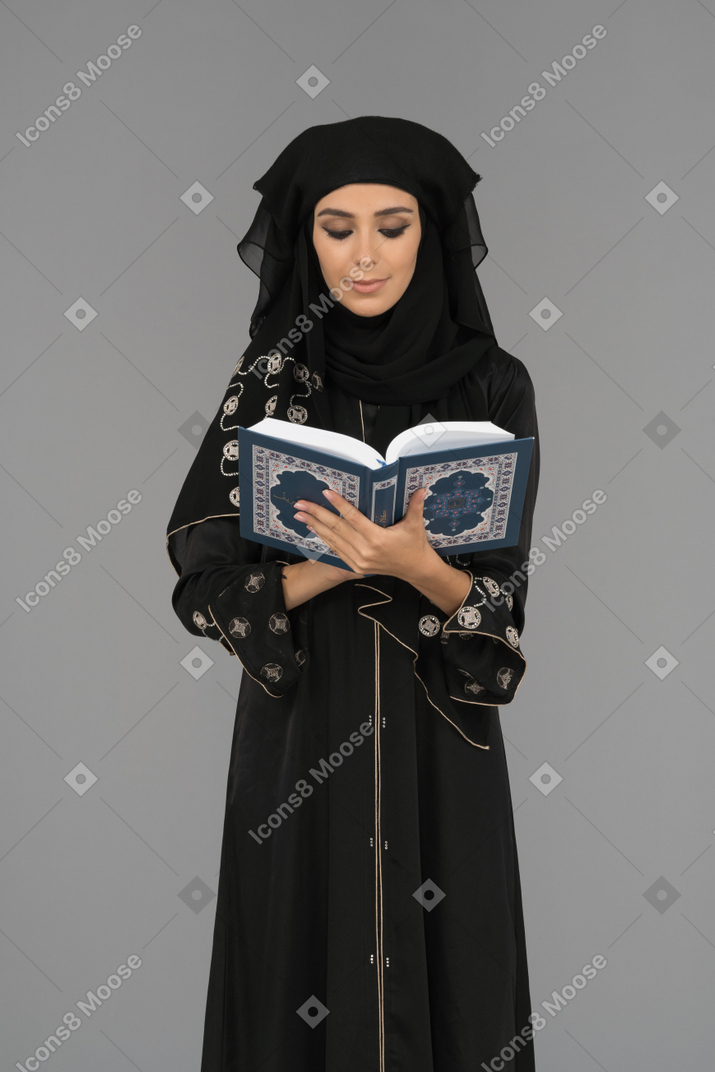 A muslim woman reading the quran