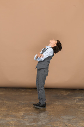 Side view of a boy in suit bending down