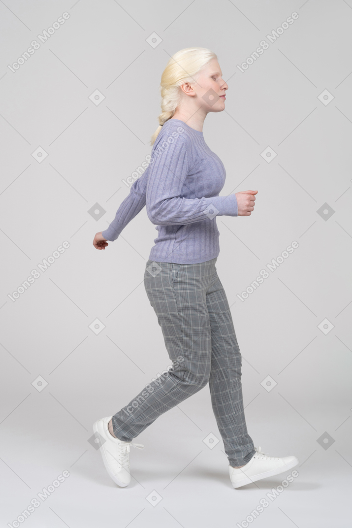 Young woman running right