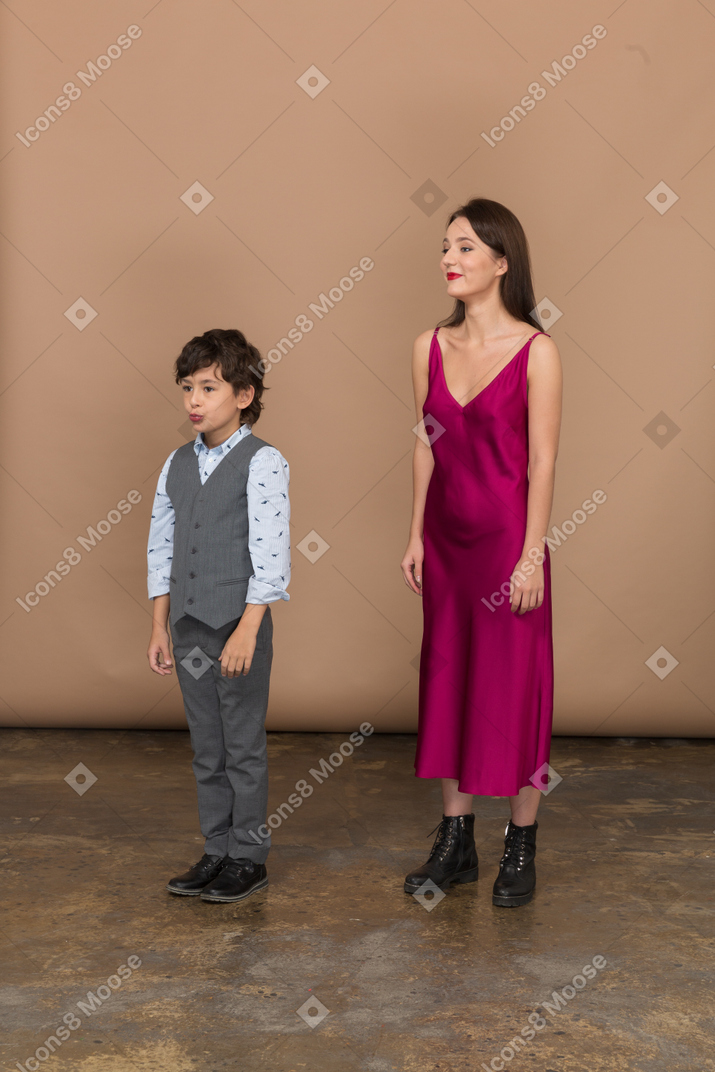 Boy and mother standing and smiling