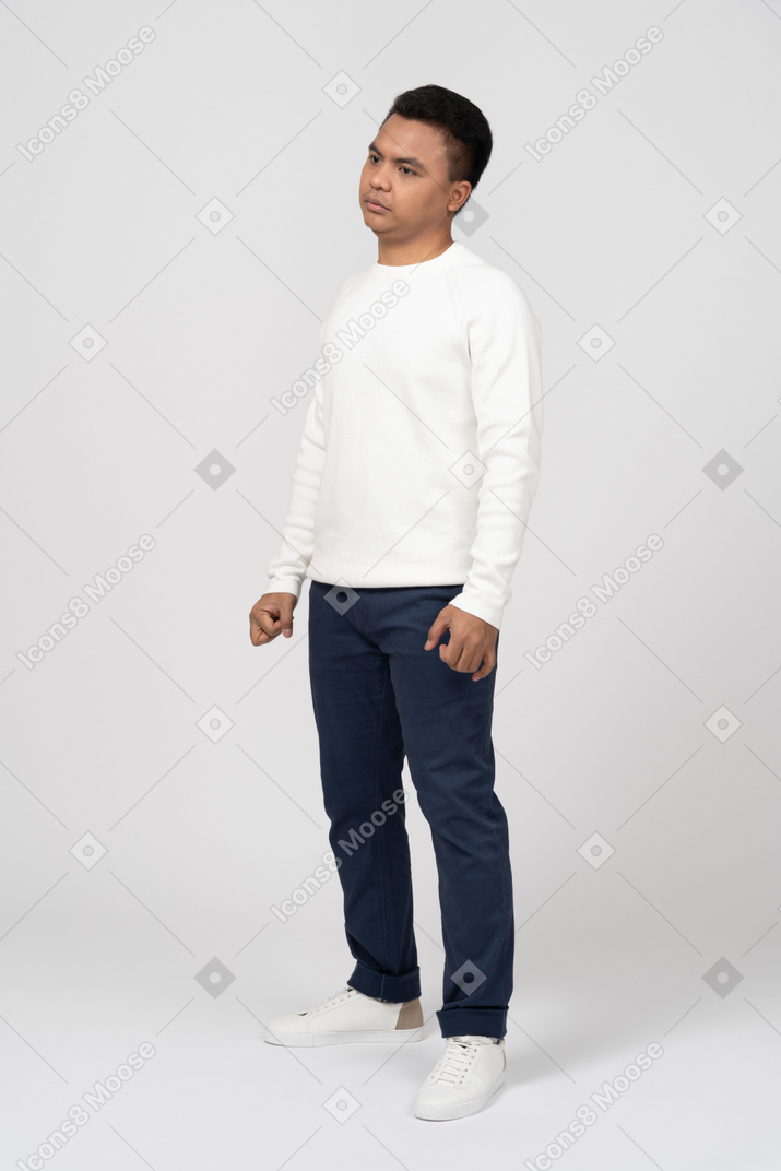 A man in a white sweater and blue pants