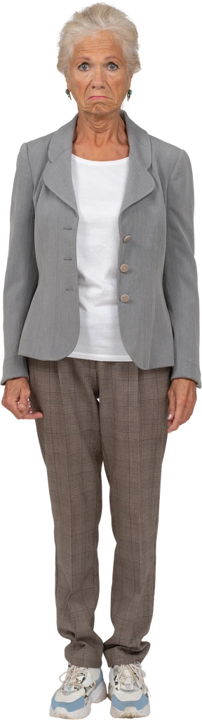 Vista frontal de una anciana en traje mirando a la cámara y haciendo muecas
