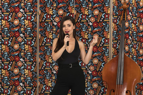 Smiling young woman singing and gesturing