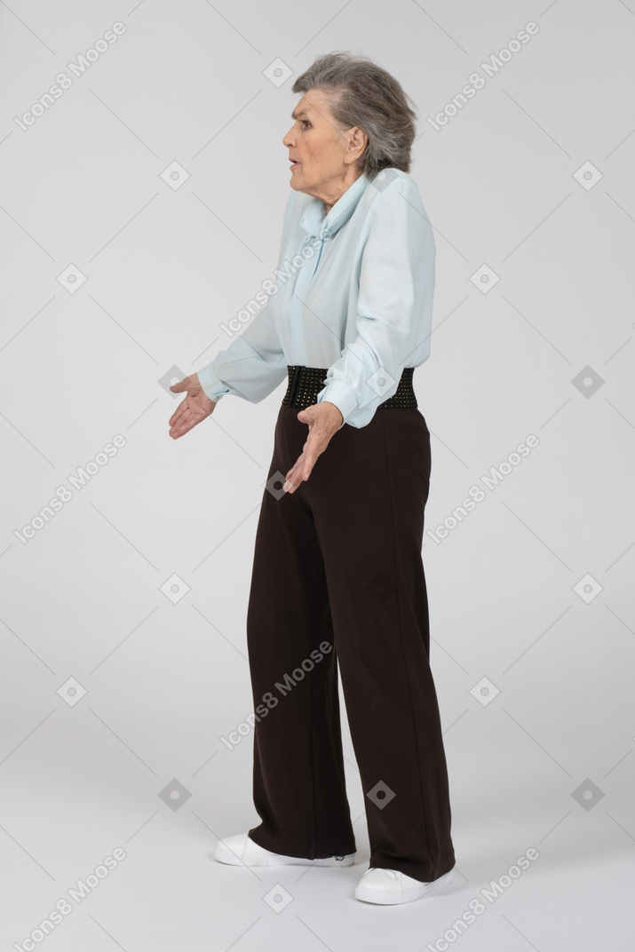 Side view of an old woman shrugging in question