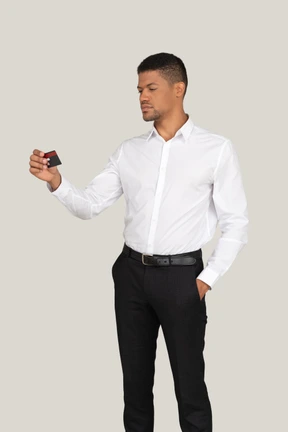 Man looking at credit card in hand