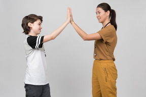 Pe teacher and pupil clapping hands together