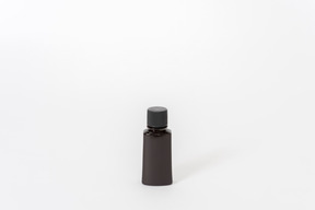 Black perfume bottle on white background