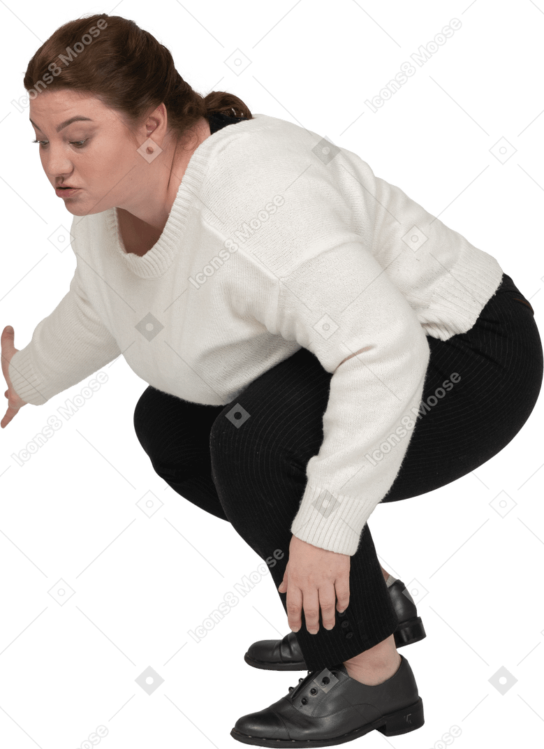 Side view of a plus size woman in casual clothes squatting