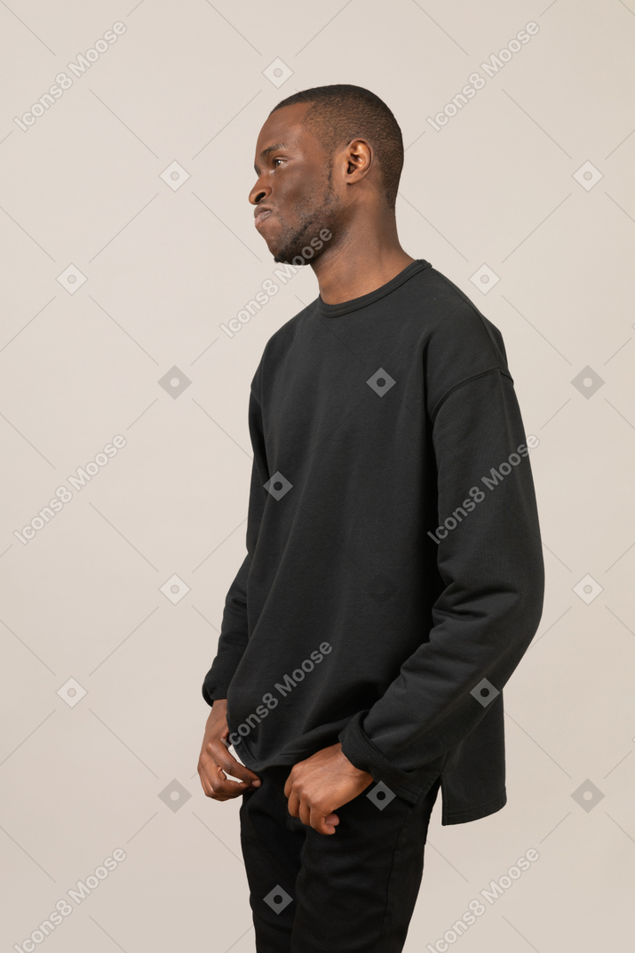 Side view of man with hands in pockets
