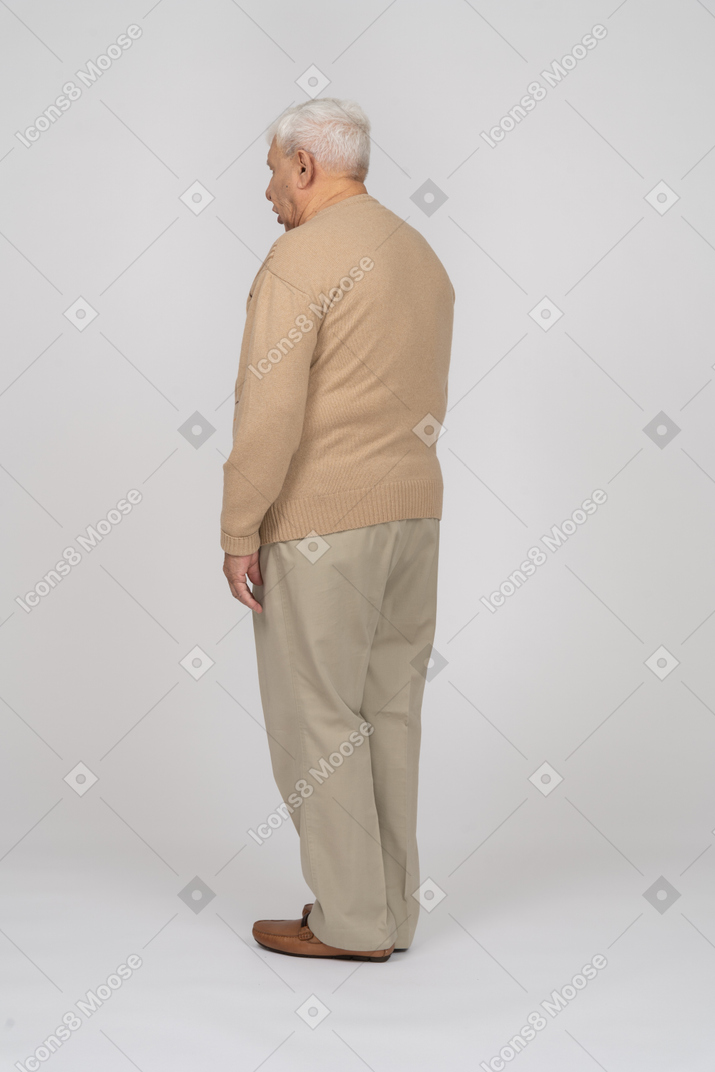 Side view of an old man un casual clothes standing still
