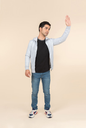 Young caucasian man waving