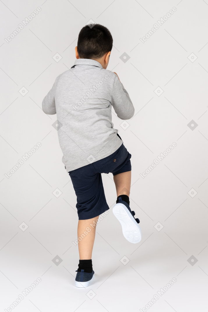 Rear view of a boy in fighting position