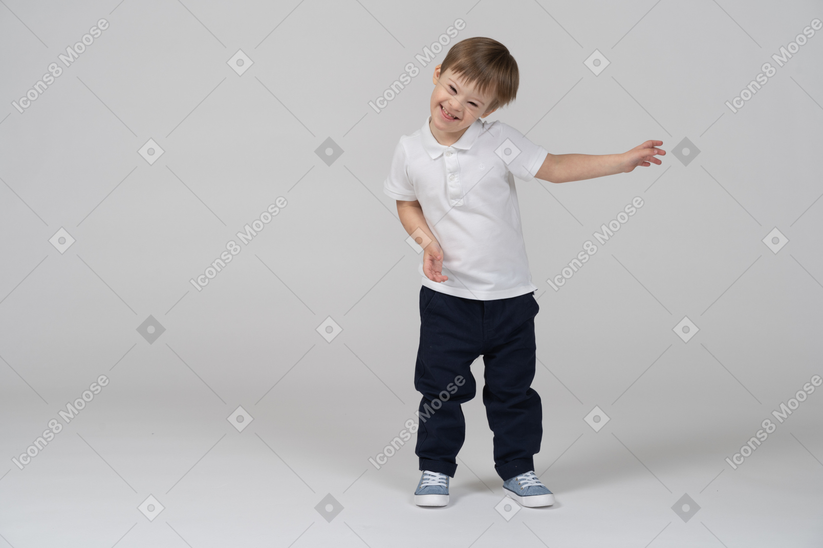 Front view of a boy waving hands and laughing