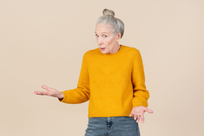 Elegant older woman looking surprised