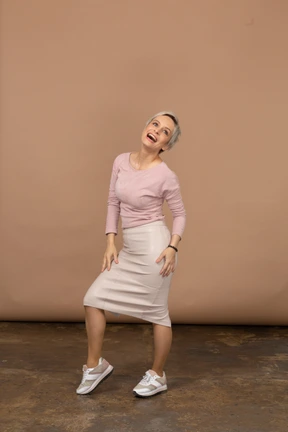 Front view of a happy woman in casual clothes posing and looking at camera