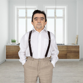 A man in a white shirt and brown suspenders