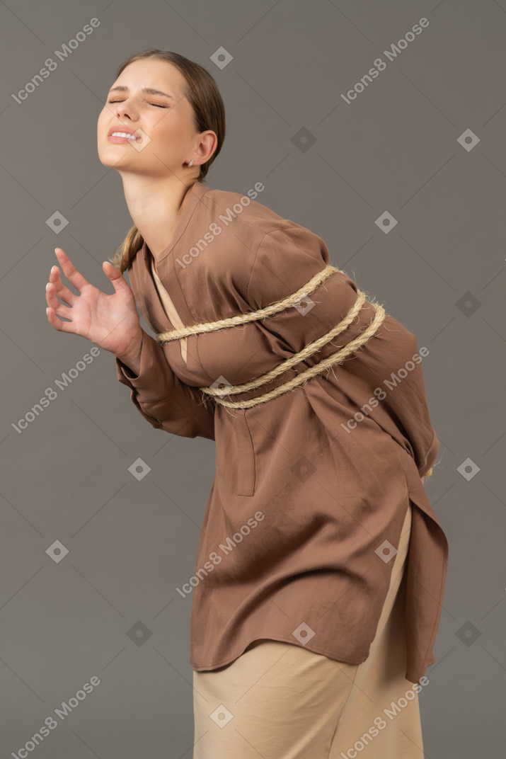 Tied up young woman in uncomfortable position