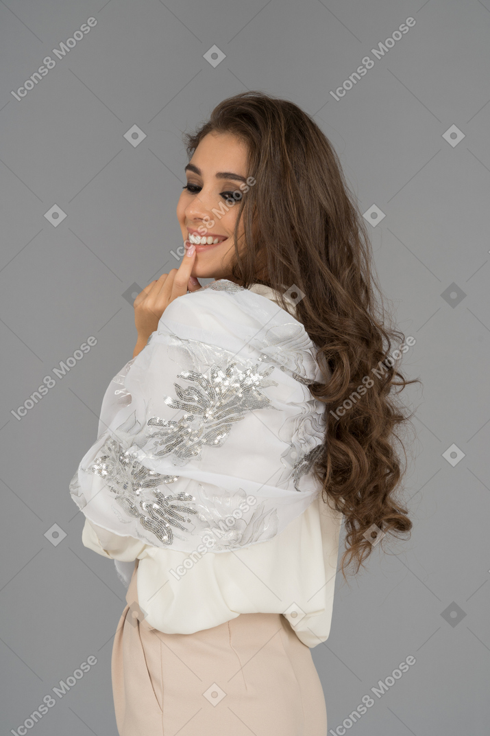 Cute smiling young woman gesturing in profile