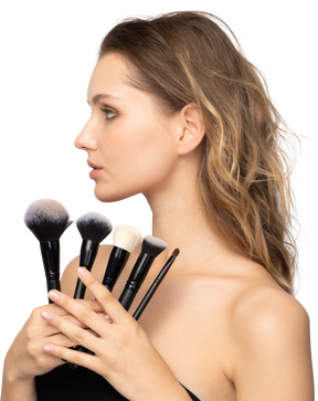 Three-quarter view of a sensual young woman holding make-up brushes