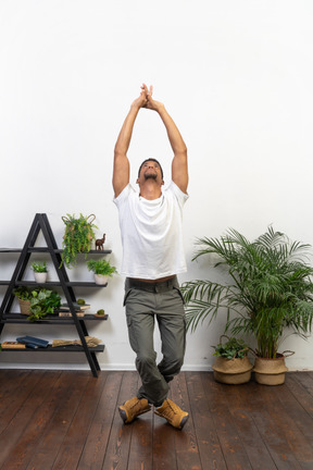 Handsome athletic man posing on the background of the apartment