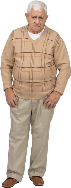 Front view of a confused old man in casual clothes looking at camera
