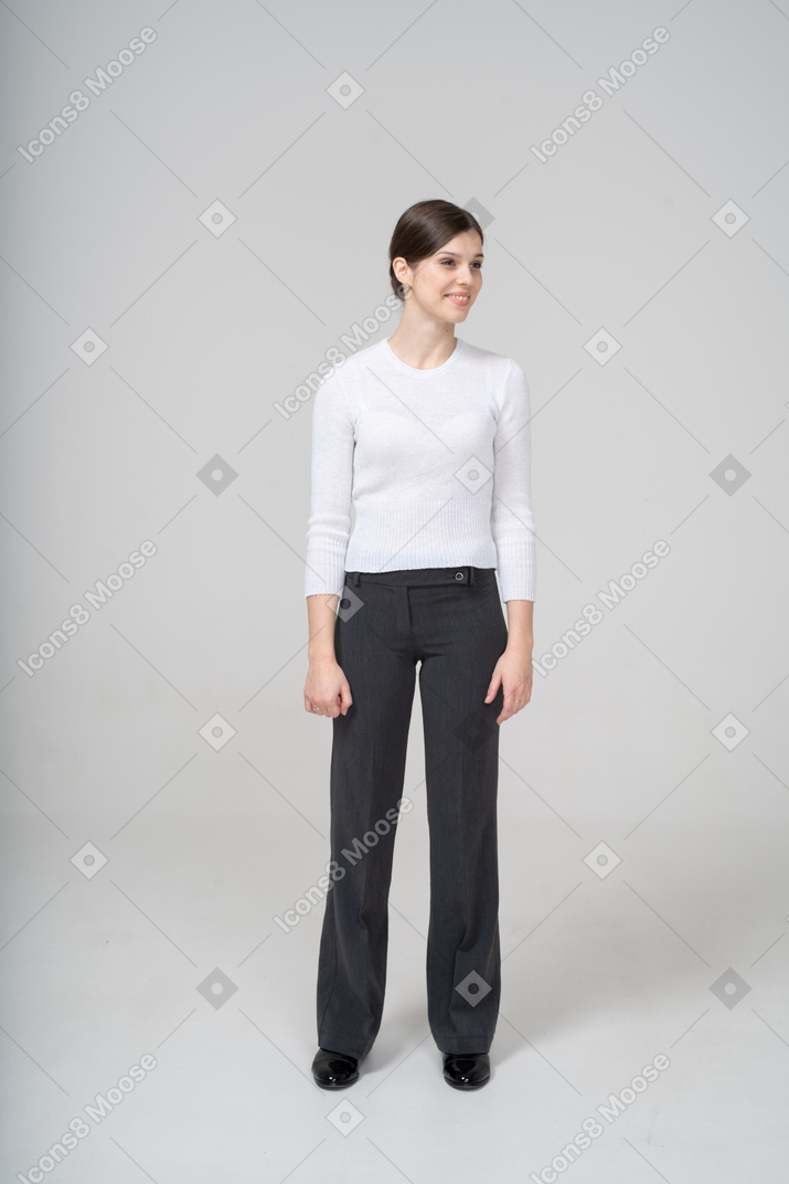 Front view of a happy woman in white blouse and black pants