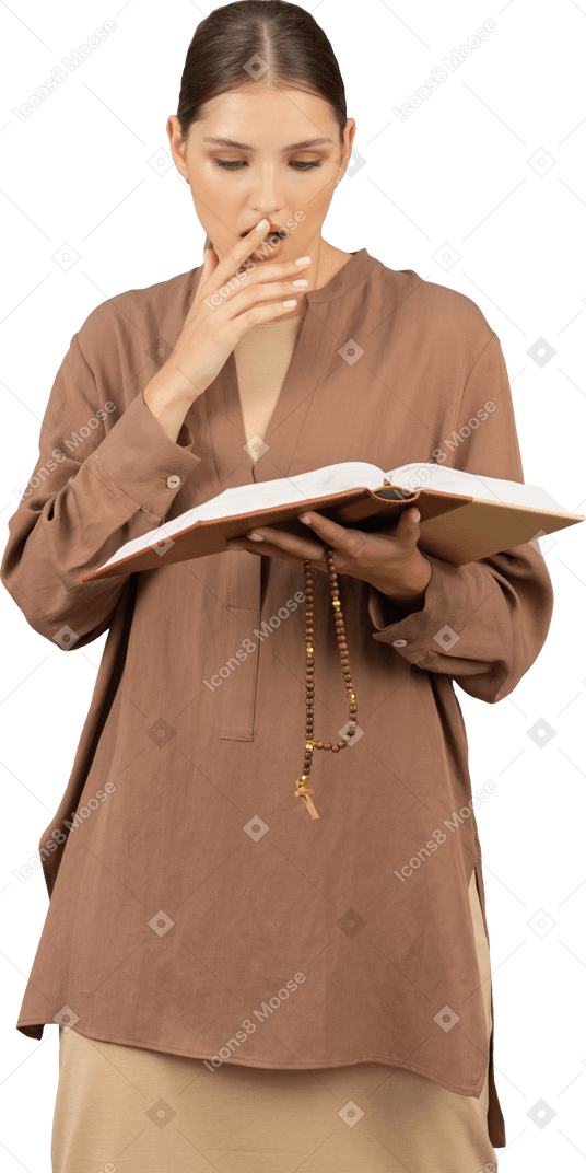 Woman reading a book while touching her lips